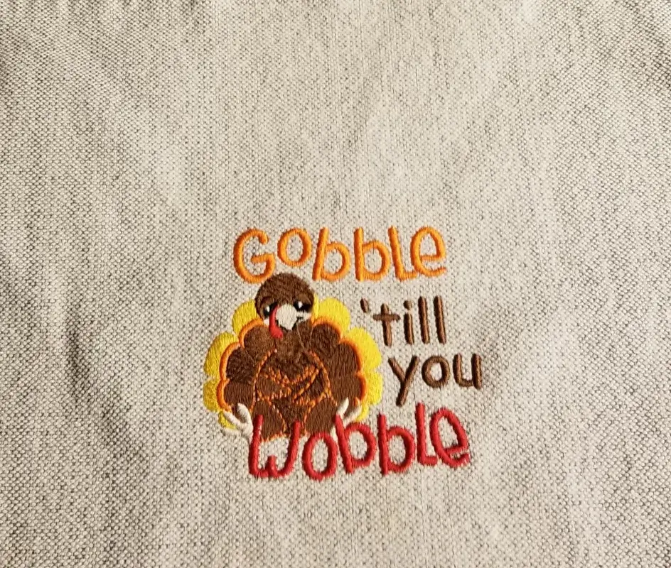 Turkey embroidery with "Gobble till you Wobble".